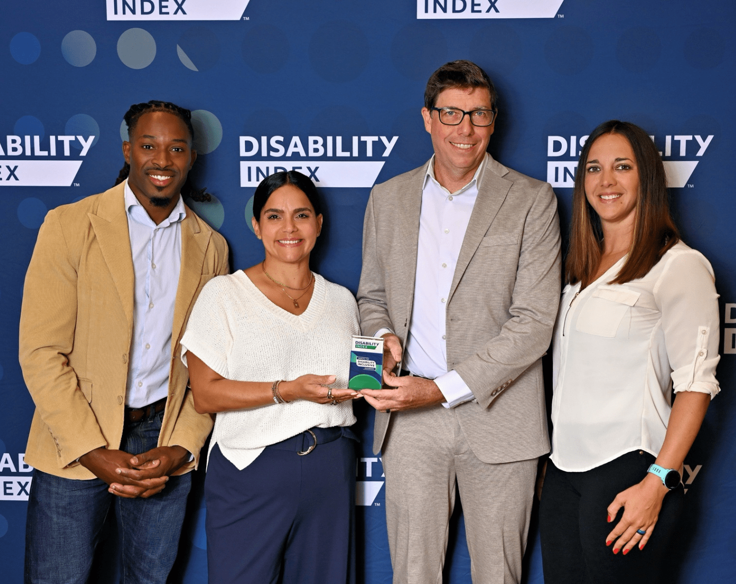 Aramark team members pose with an award at the Disability IN conference.
